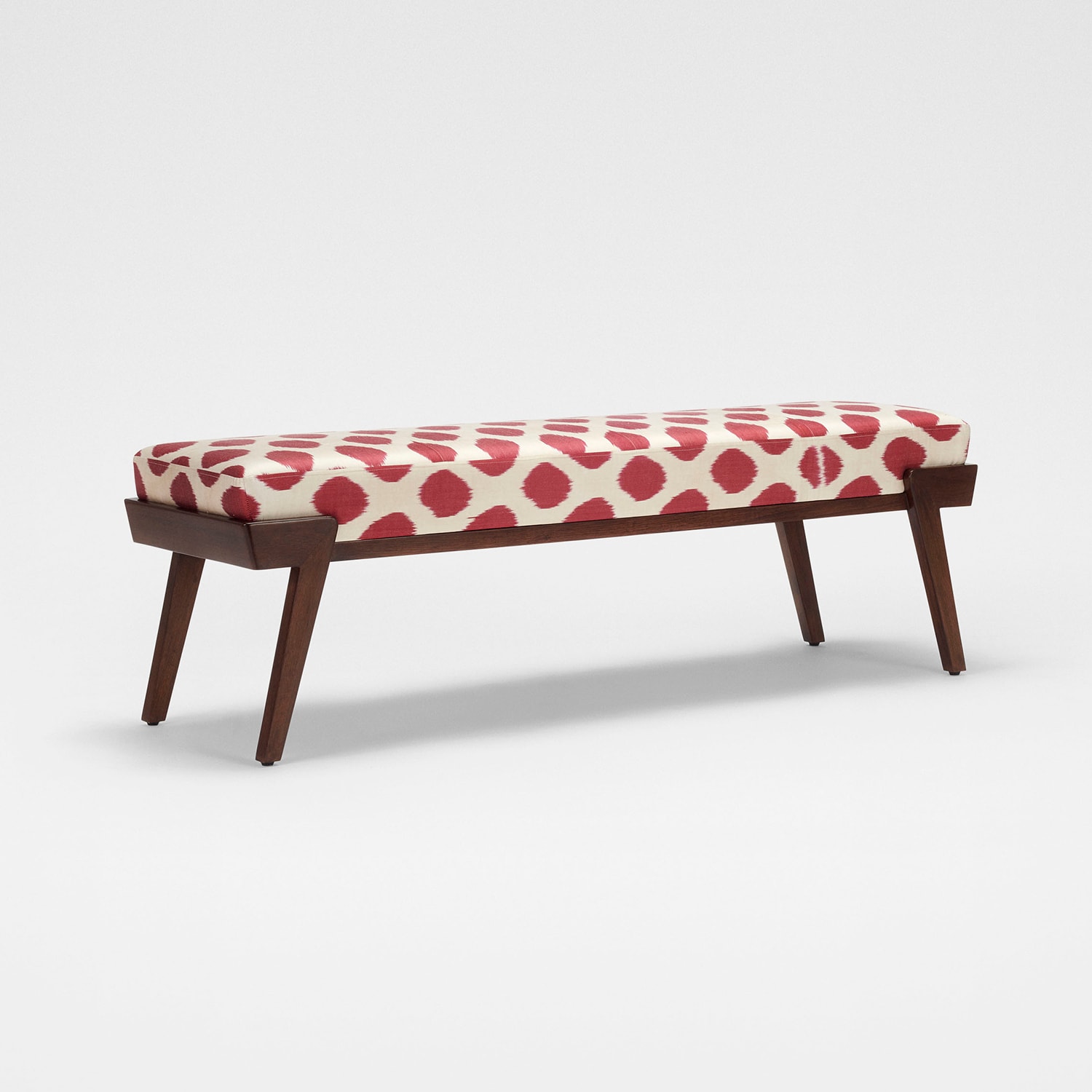 Svelte bench in teakwood frame and upholstered seat in a bold central asian silk ikat